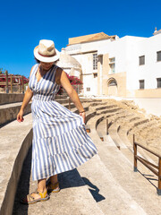 Caucasian tourist woman enjoying the Roman Theatre of Cadiz, Spain.