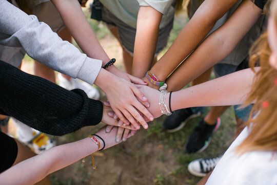 Team of children put hands together.Peaceful Protest kids group and protester unity in a fist of diverse people connected together as a nonviolent resistance symbol of justice and fighting