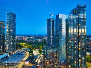 Aerial photo of Manchester skyscrapers and new development taken from Castlefield, showing the constant changing vibrant skyline during the blue hour.