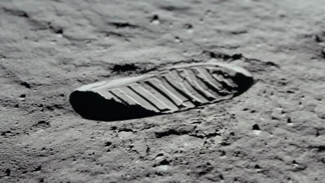 Lunar astronaut walking on the moon's surface and leaves a footprint in the lunar soil. 3d rendering. Some Elements of this video furnished by NASA.