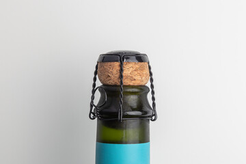 the neck of a bottle corked with a champagne cork