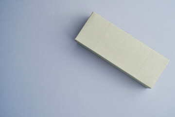 Colored small gift box on a white background. Postal services, delivery. Mock-up packaging. Gift box, gift. Box close-up. Empty packaging, empty space