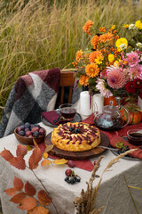 Thanksgiving dinner preparation. Table with pumpkin, autumn season pie. Decorated kitchen in Halloween season. Cooking celebration feast. Fall seasonal table.