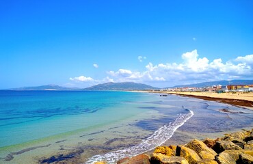long sandy beach and dunes in Tarifa with a view towards the dune of Valdevaqueros at a beautiful...
