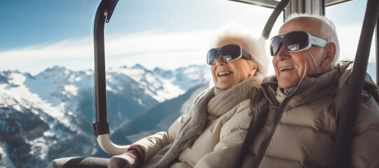 An elderly couple aboard a cable car, surprised by the views of the snowy mountains.christmas holydays, copy space