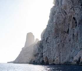 Close-up shot of Es Vedra Ibiza against a blue sky backdrop with sunlight