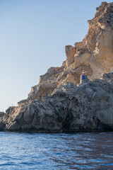 A rock-built lighthouse on Es Vedra illuminated by the sun