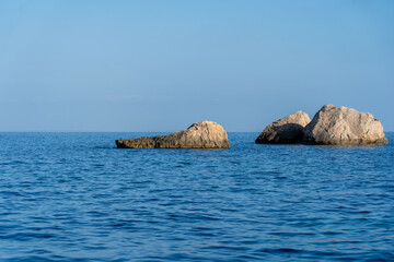 A rock perched over the blue sea of Ibiza