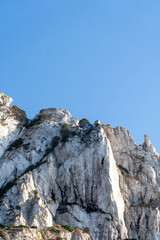 Close-up shot of Es Vedra Ibiza against a blue sky backdrop with sunlight