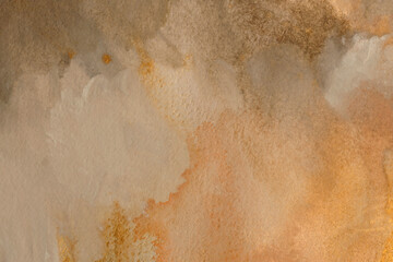 Beige, gold glitter wet watercolor paper texture background.