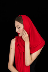 beautiful young woman wearing red in retro fashion style isolated on black background in studio © Andrey Cherkasov