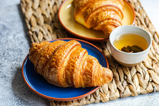 Fresh baked croissants on ceramic plates