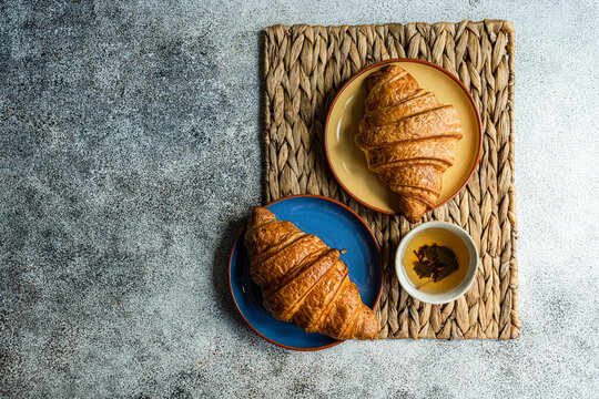 Fresh baked croissants on ceramic plates