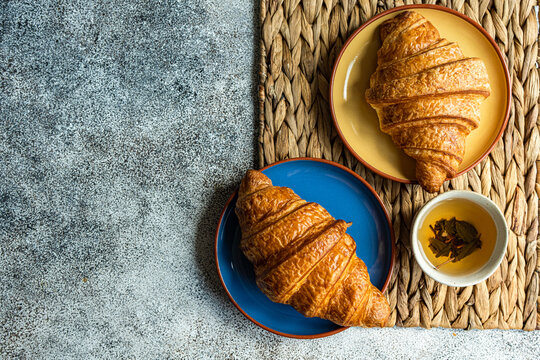 Fresh baked croissants on ceramic plates