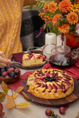 Thanksgiving dinner preparation. Table with pumpkin, autumn season pie. Decorated kitchen in Halloween season. Cooking celebration feast. Fall seasonal table.