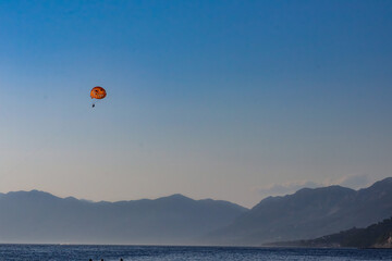 Parasailing on the Adriatic Sea in Makarska riviera with mountain view