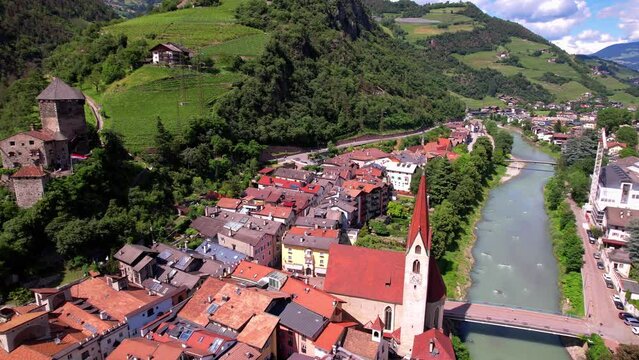 Chiusa Klausen Italy 4k aerial cinematic of Sabiona Abbey monastery and medieval castle in South Tyrol. Scenic alpine village in Isarco valley with vineyards and Dolomites mountains. Travel footage