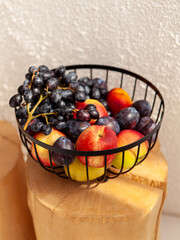Metal fruit basket on white wall background. Home and kitchen decor. Natural. Fruit bowl