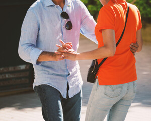 heterosexual latino hispanic couple dancing outdoors in summertime