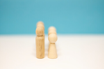 Leadership concept. Wood person model among people. Man and woman standing. Concept of Human resource, Talent management