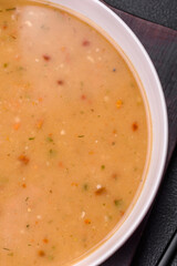 Delicious fresh vegetable soup with carrots, peppers, potatoes and onions