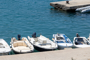 Sea pier with moored boats, bright sunny day