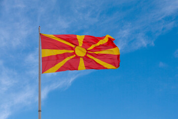 North Macedonian flag waving atop of its pole