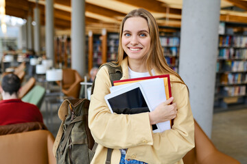 Smiling cute pretty blond girl, positive female teenage high school student holding backpack...