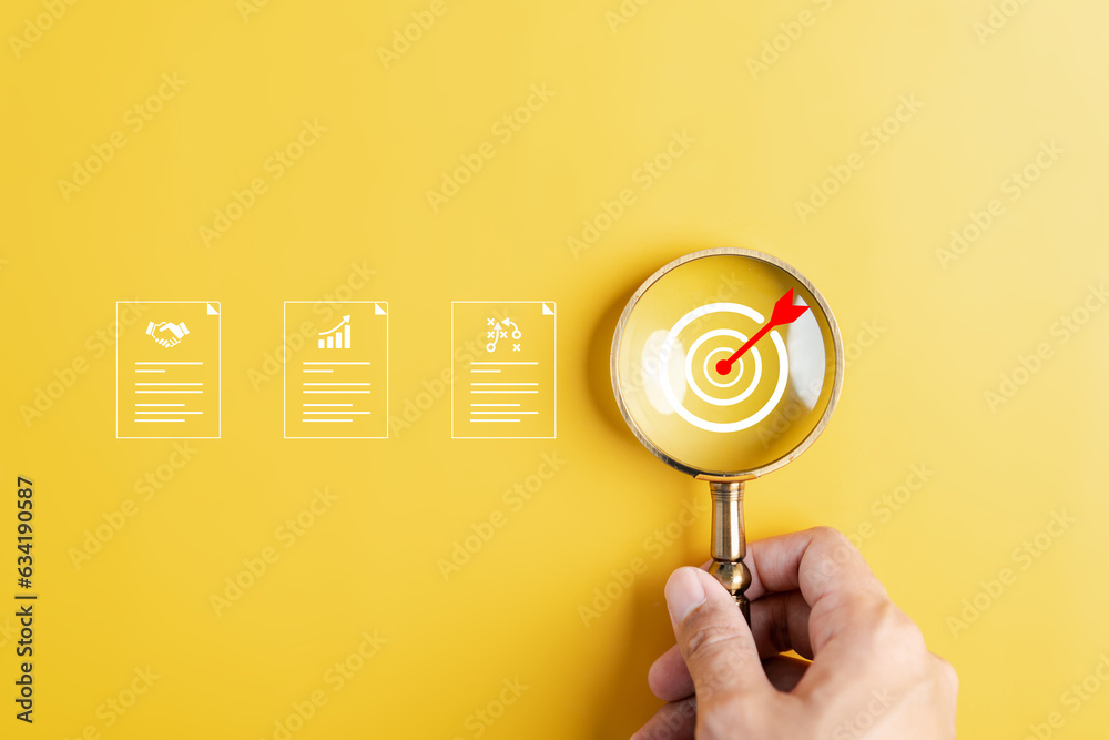 Poster magnifier glass focus to target dart board with business document for planning development leadershi
