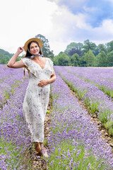 A woman in a white dress among lavender fields