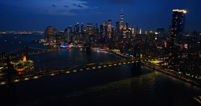 Vibrant New York at night. Lively traffic on the roads and bridges of the city. Beautiful sparkling panorama from drone.