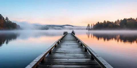 Fotobehang A straight flat simplistic rectangular lake dock, beautiful sunrise, foggy, calm water. Nature relax wallpaper. © dinastya