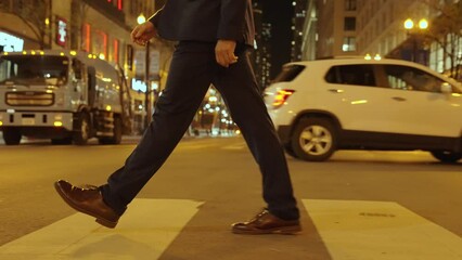 busy city. man walk in the crowded street. legs crossing the pedestrian crosswalk. street road in metropolis city. city crossing. cross the street in heart of city. man confidently crosses the street