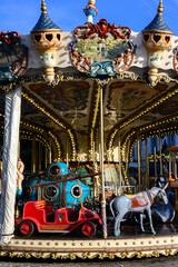 Colorful traditional old french caroussel in city park in sunny day