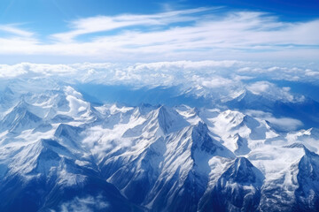 Obraz premium Awe-Inspiring Aerial View of Majestic Mountain Range with Snow-Capped Peaks and Lush Green Valleys