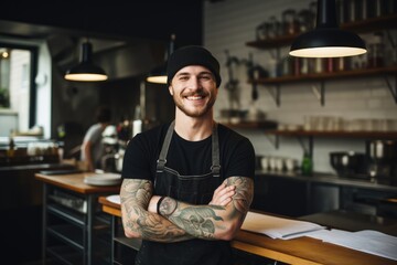 Young male caucasian chef working in a restaurant kitchen smiling portrait