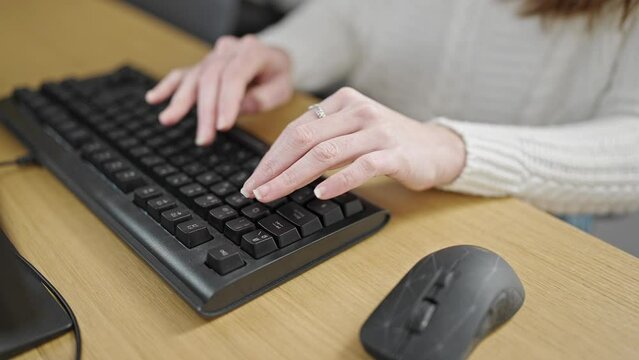 Young hispanic woman using computer keyboard at office