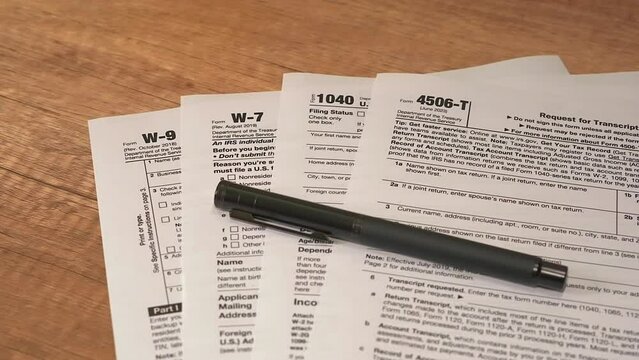 tax forms with pen on a table