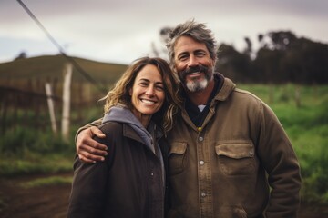 Middle aged caucasian couple living on a farm in the countryside smiling portrait