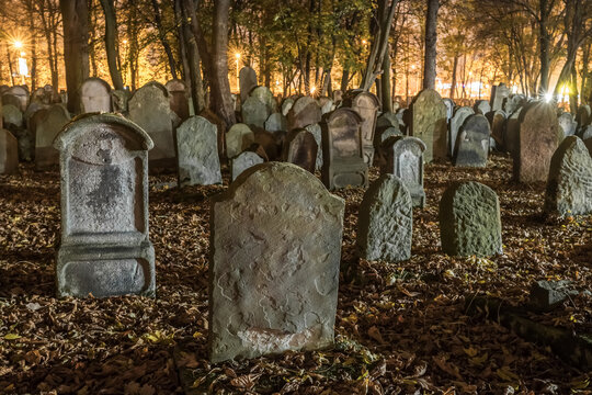Tombstones in an old cemetery at night.
