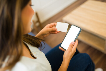 Smiling woman doing online shopping on the smartphone