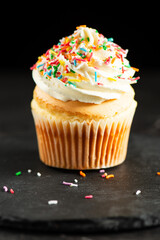 Soft and delicate vanilla cupcake with buttercream and rainbow sprinkles.