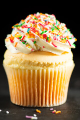Soft and delicate vanilla cupcake with buttercream and rainbow sprinkles.