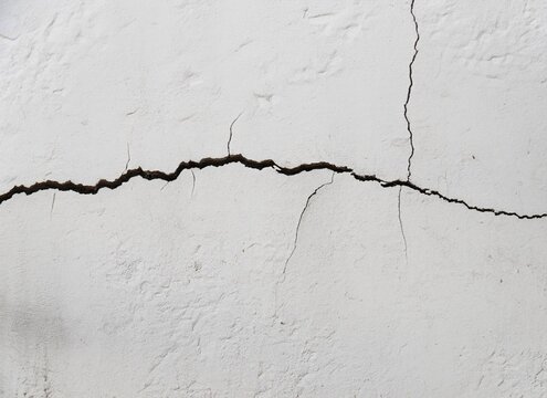 Cracks on A White Concrete Wall