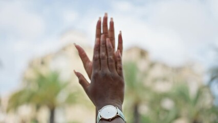 African american woman clapping hands at street