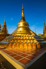 Pagoda gold and church in wat thai reflect with sun sky in day time in Bangkok Thailand.