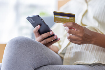 Small business entrepreneur SME freelance pregnant african woman work from home her hand holding credit card with box, online marketing packaging mail box and delivery, SME e-commerce concept