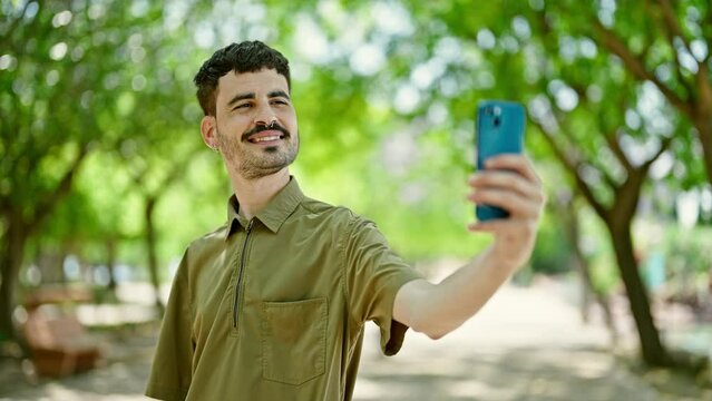 Young hispanic man smiling confident making selfie by the smartphone at park