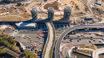 Aerial drone view above the large chimney towers near Rozelle Interchange in Sydney, NSW showing major construction works along City West Link in August 2023 