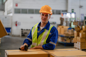 portrait of a smart Caucasian male engineer inspector checking confidence with a background of the warehouse of product stock